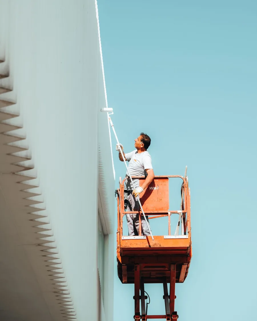 Painter decorating a building exterior